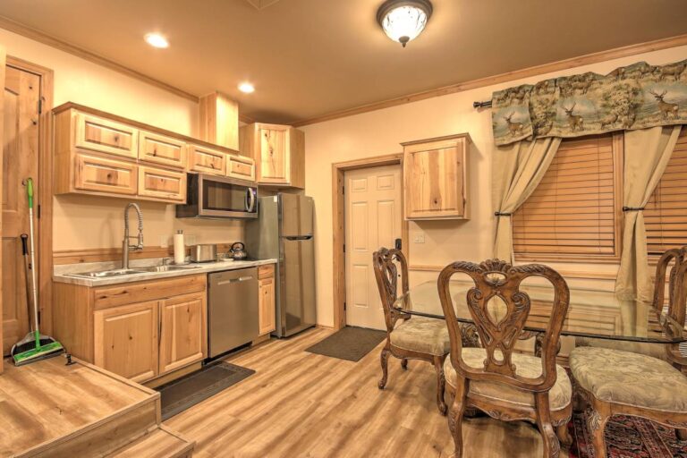 A cozy kitchen featuring a table, chairs, and a refrigerator, creating a welcoming dining space