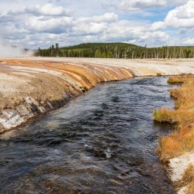 The stunning Grand Canyon of the Yellowstone River, featuring steep, colorful walls and the flowing river below