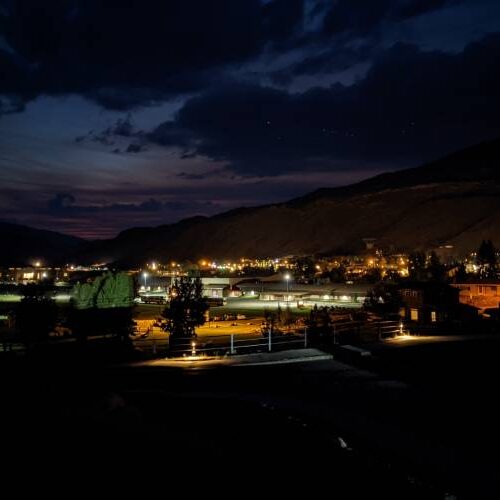 A serene night sky filled with stars above a quiet town, casting a peaceful ambiance over the landscape